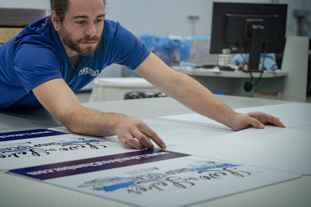 Firebolt engineer working with printed signs for local businesses