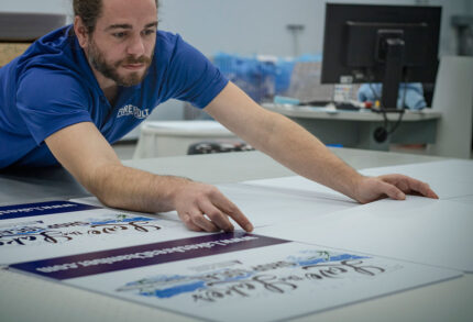 Firebolt engineer working with printed signs for local businesses