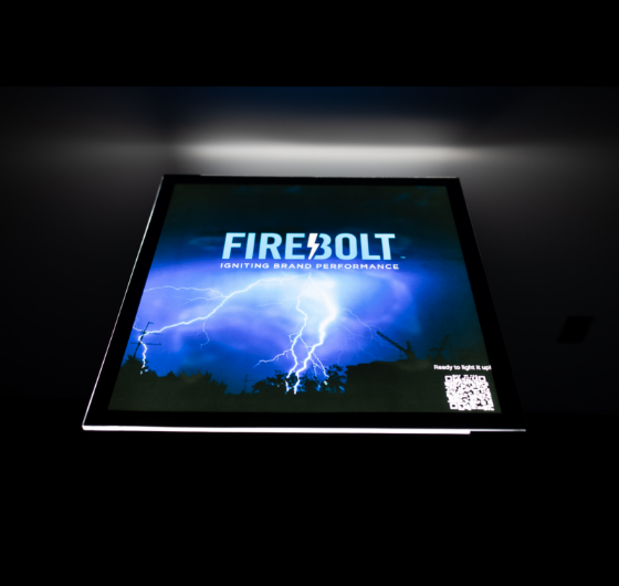Illuminated table top display showing the Firebolt logo